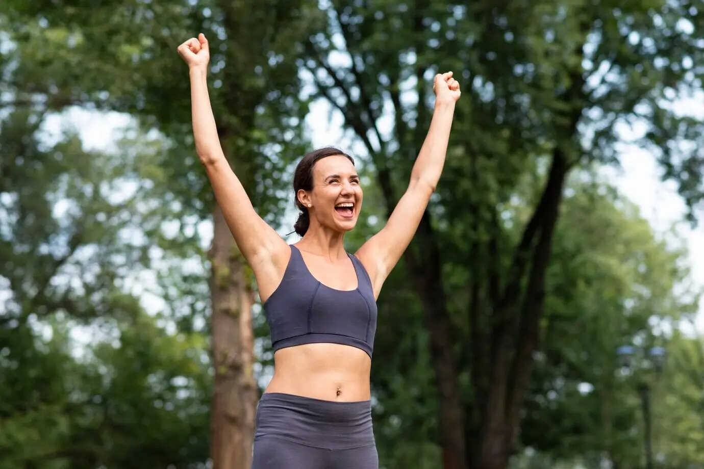 A medium shot of a woman expressing victory.